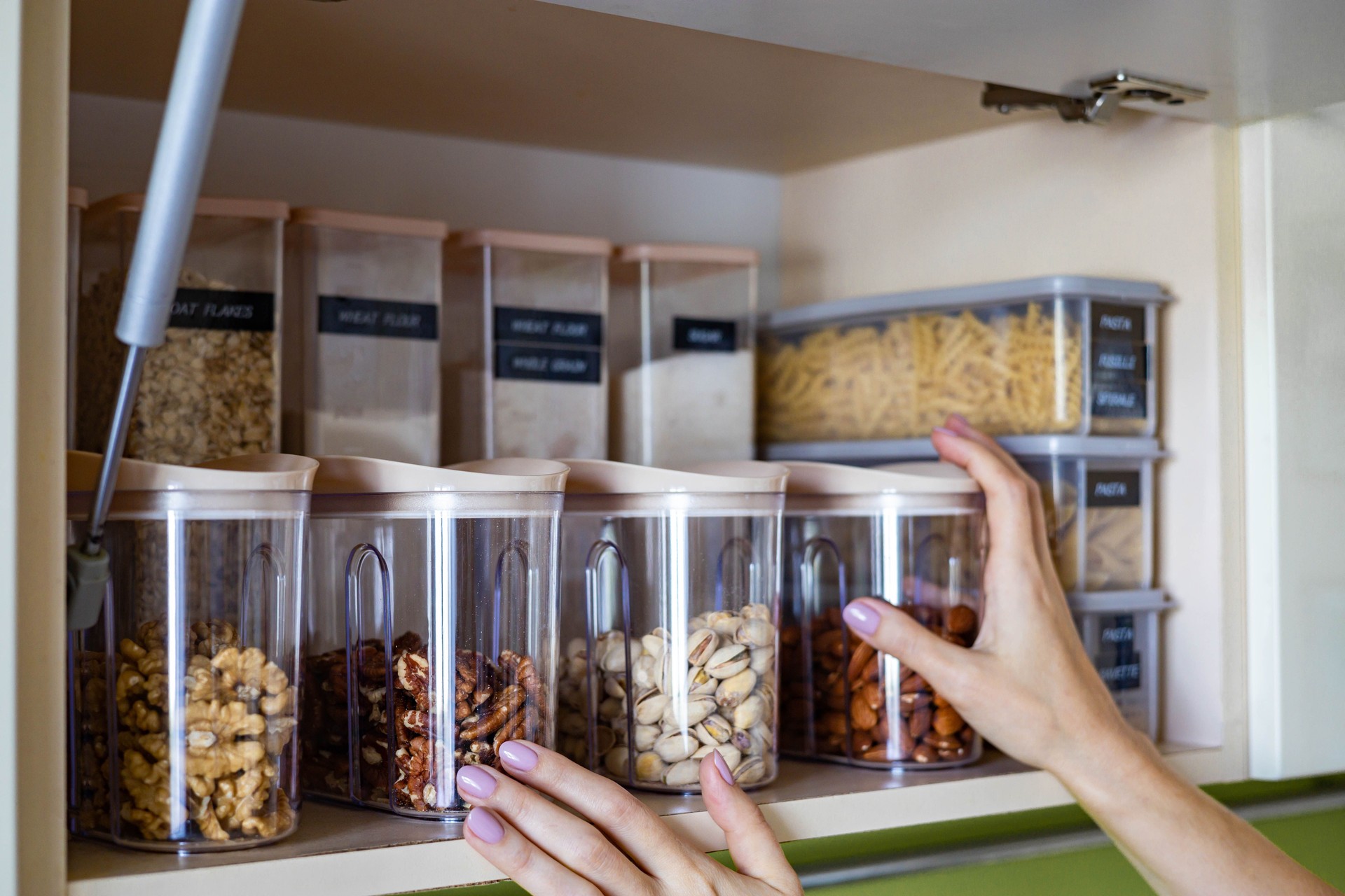 Domestic healthy vegetarian dry food storage organization on shelf at kitchen cupboard